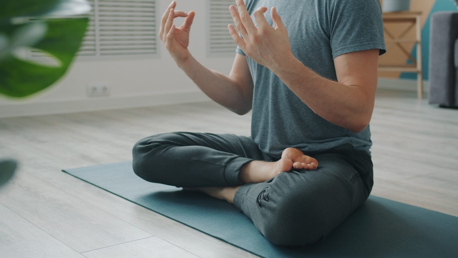Photo by Vitaly Gariev Man meditating in lotus pose on yoga mat